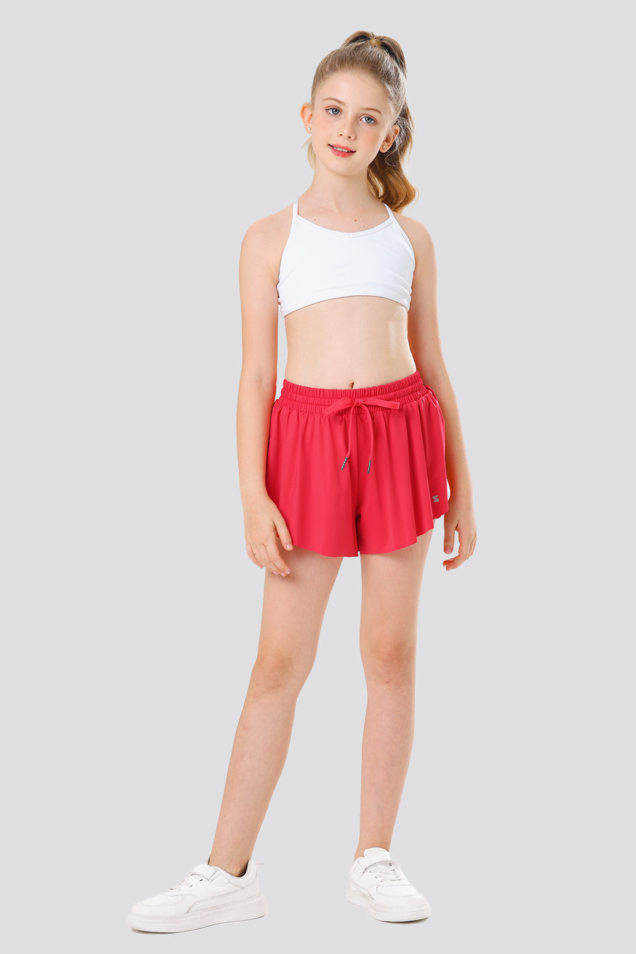 Girl wearing red butterfly shorts