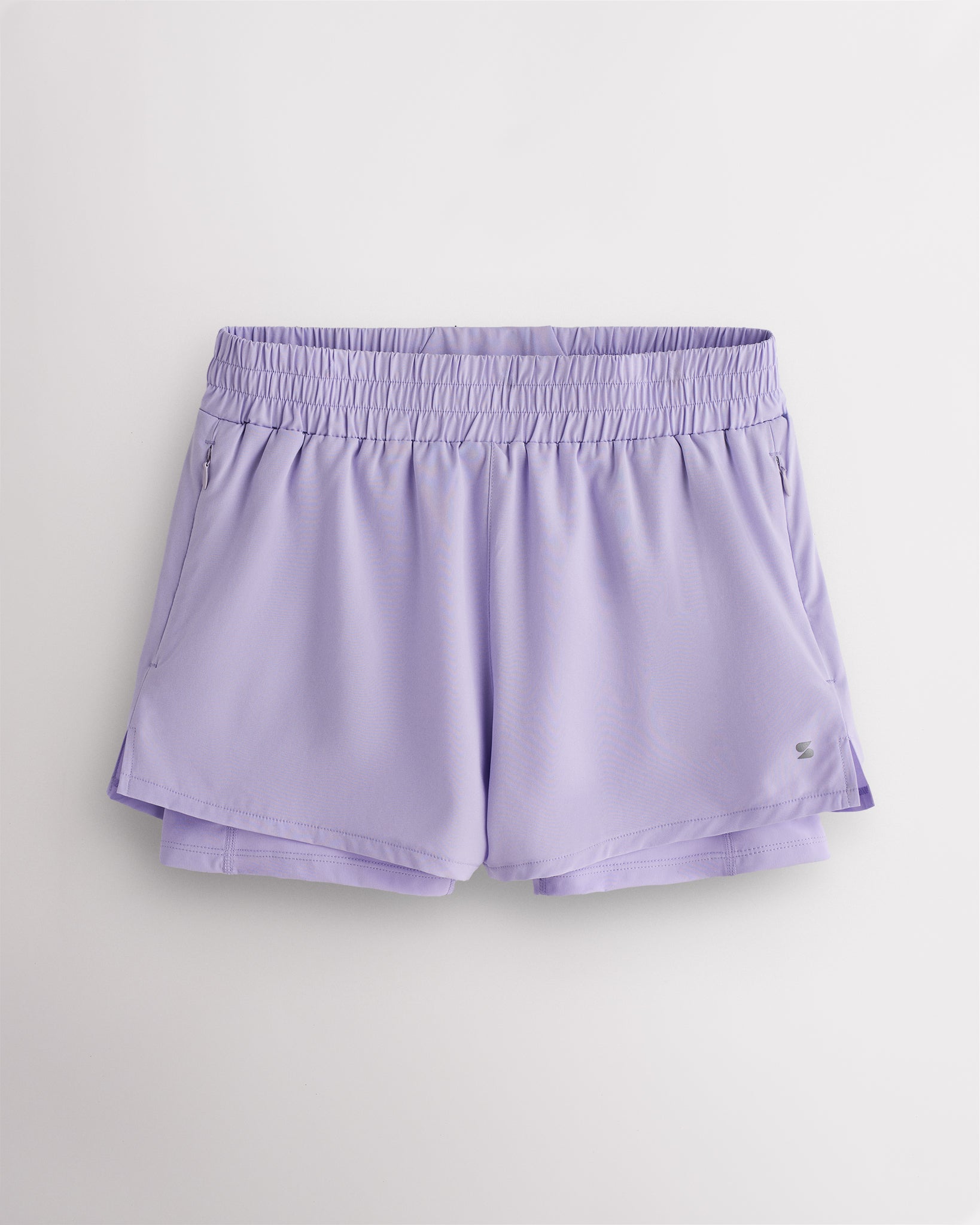 Lavender Stelle women’s 2-in-1 running shorts with elastic waistband, zipper pockets, inner shorts liner, and curved side hems.