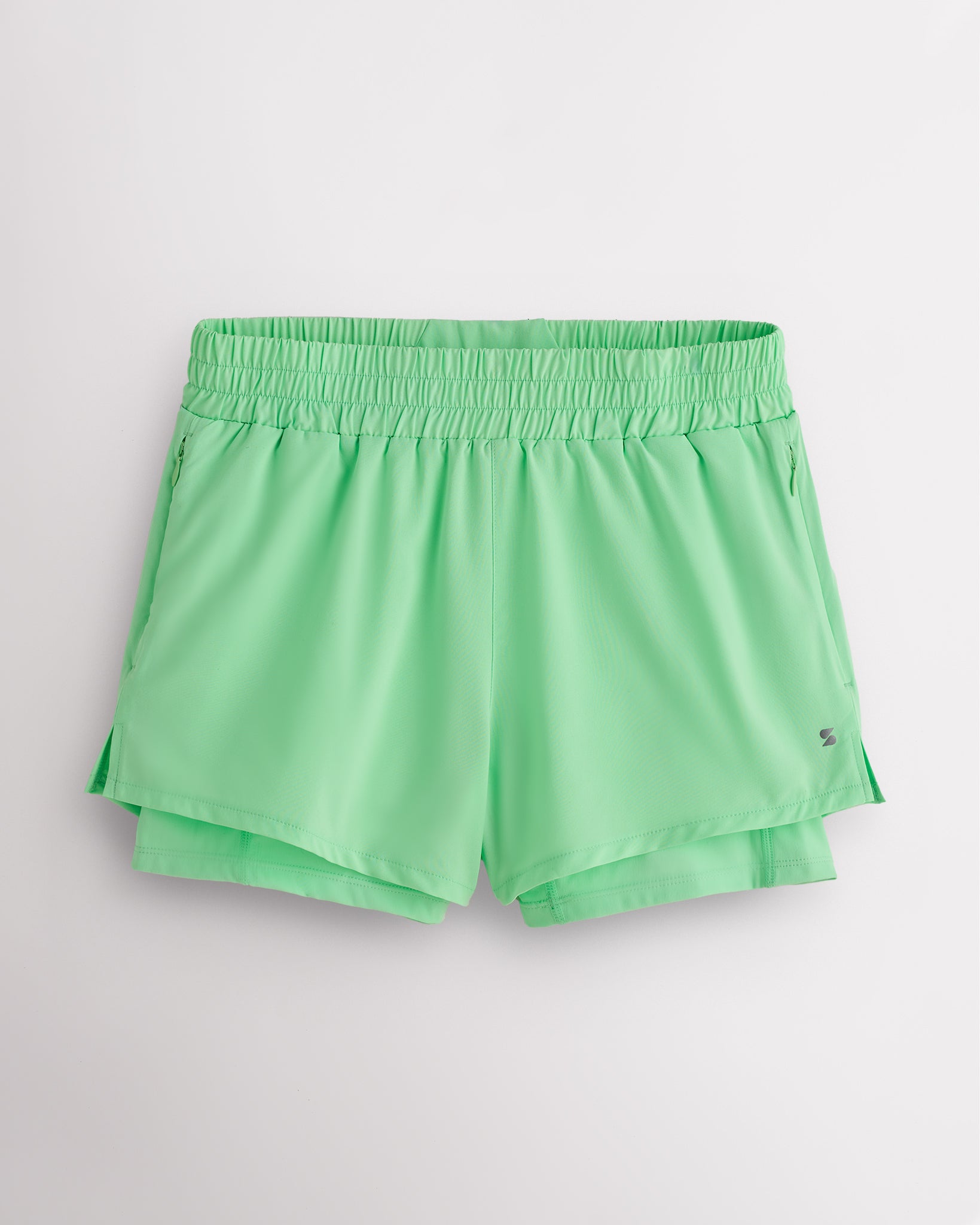 Neon Green Stelle women’s 2-in-1 running shorts with elastic waistband, zipper pockets, inner shorts liner, and curved side hems.