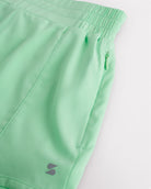 Close-up of girls athletic shorts showing soft stretchy material, elastic waistband, and zip pocket detail