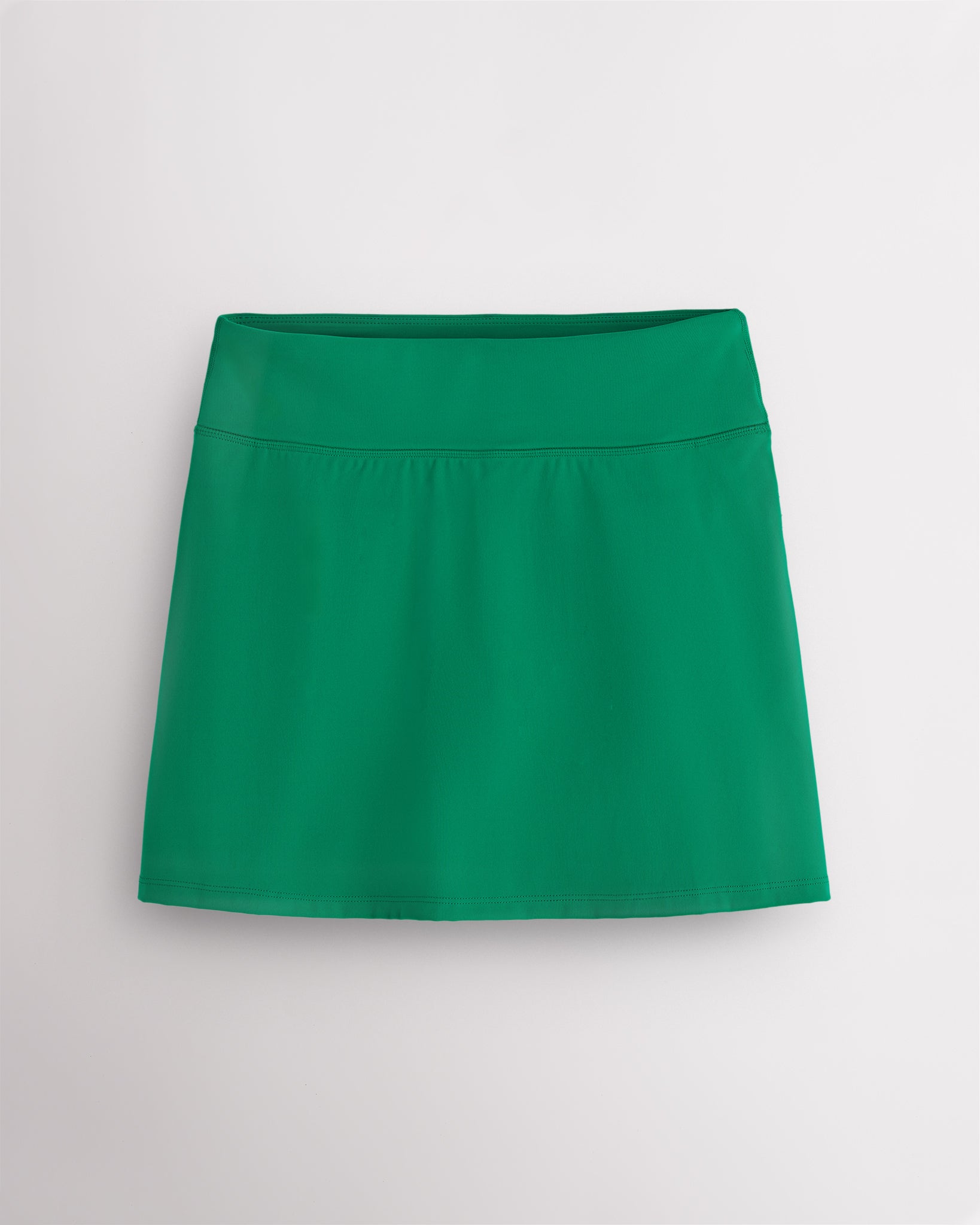 Kelly green Stelle Ruffle Ace tennis skirt with a high-waisted fit, lightly flared silhouette, and smooth stretch fabric.