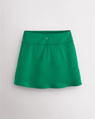 Back view of kelly green Stelle Ruffle Ace tennis skirt showing double-layer ruffle detail, high waistband, and Stelle logo.
