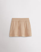 A quick-dry khaki tennis skirt with a smooth front, ruffle back hem, and built-in shorts with pockets for comfortable coverage on and off the court.