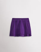 A quick-dry purple tennis skirt with a smooth front, ruffle back hem, and built-in shorts with pockets for comfortable coverage on and off the court.