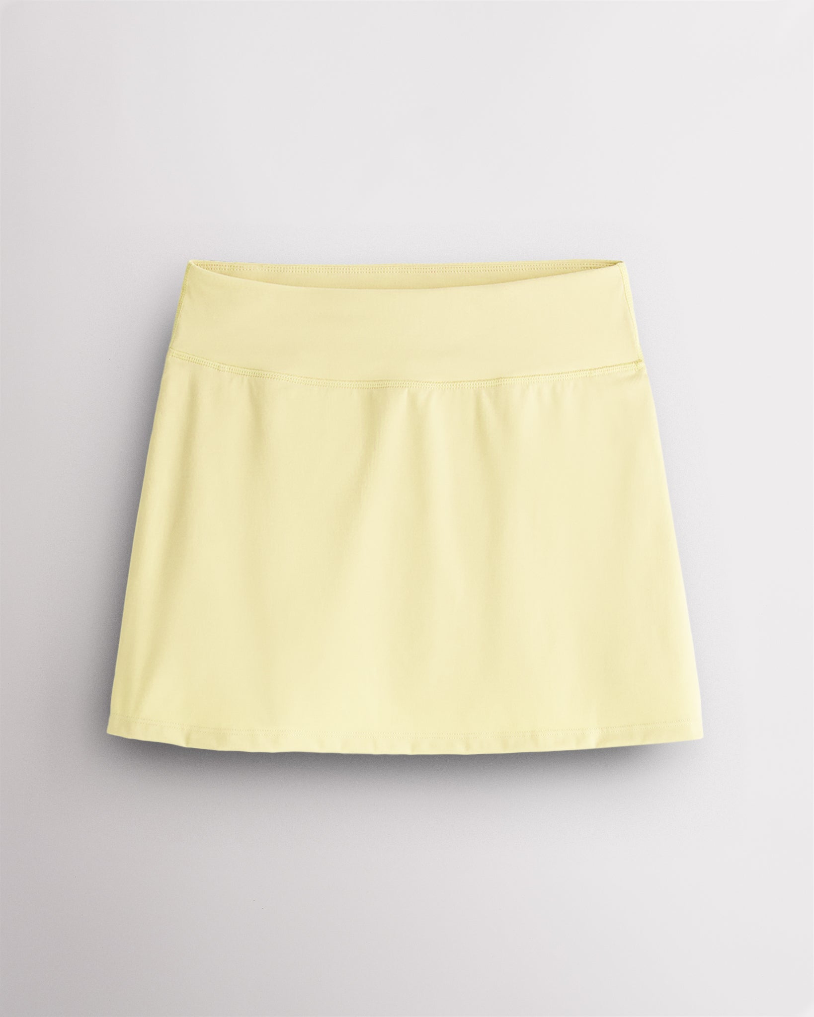 Lemon Butter Stelle Ruffle Ace tennis skirt with a high-waisted fit, lightly flared silhouette, and smooth stretch fabric.