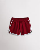 Girls crimson athletic shorts with white trim, a stretchy elastic waistband, curved hems, and lightweight sporty design.