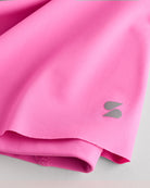 Close-up of Cotton Candy Kids Let’s Bounce Shorts showing lightweight quick-dry fabric, hem stitching, and small Stelle logo detail.
