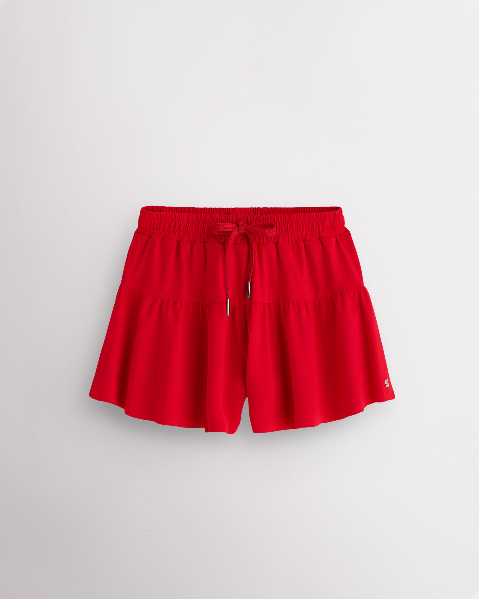 Red Kids Let’s Bounce Shorts with flowy design, elastic waistband, drawstring, lightweight fabric, and built-in lining for practice and play.
