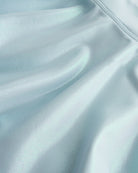 Close-up of light blue Stelle girls shimmer skort showing iridescent fabric texture and smooth seam detail