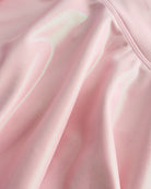 Close-up of pink Stelle girls shimmer skort showing iridescent fabric texture and smooth seam detail