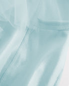 Close-up of light blue skort for girls showing sheer tiered mesh and shiny built-in shorts.