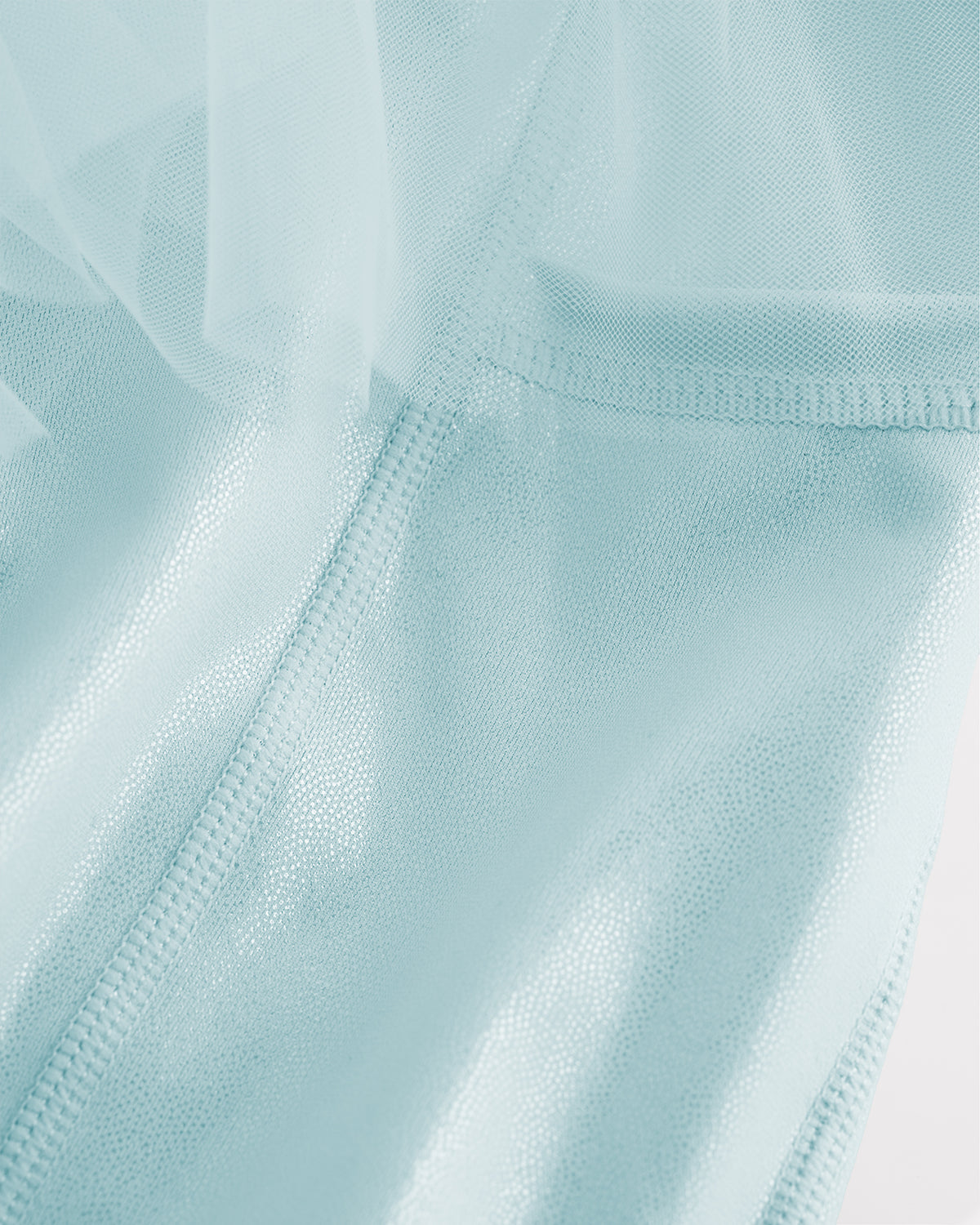 Close-up of light blue skort for girls showing sheer tiered mesh and shiny built-in shorts.