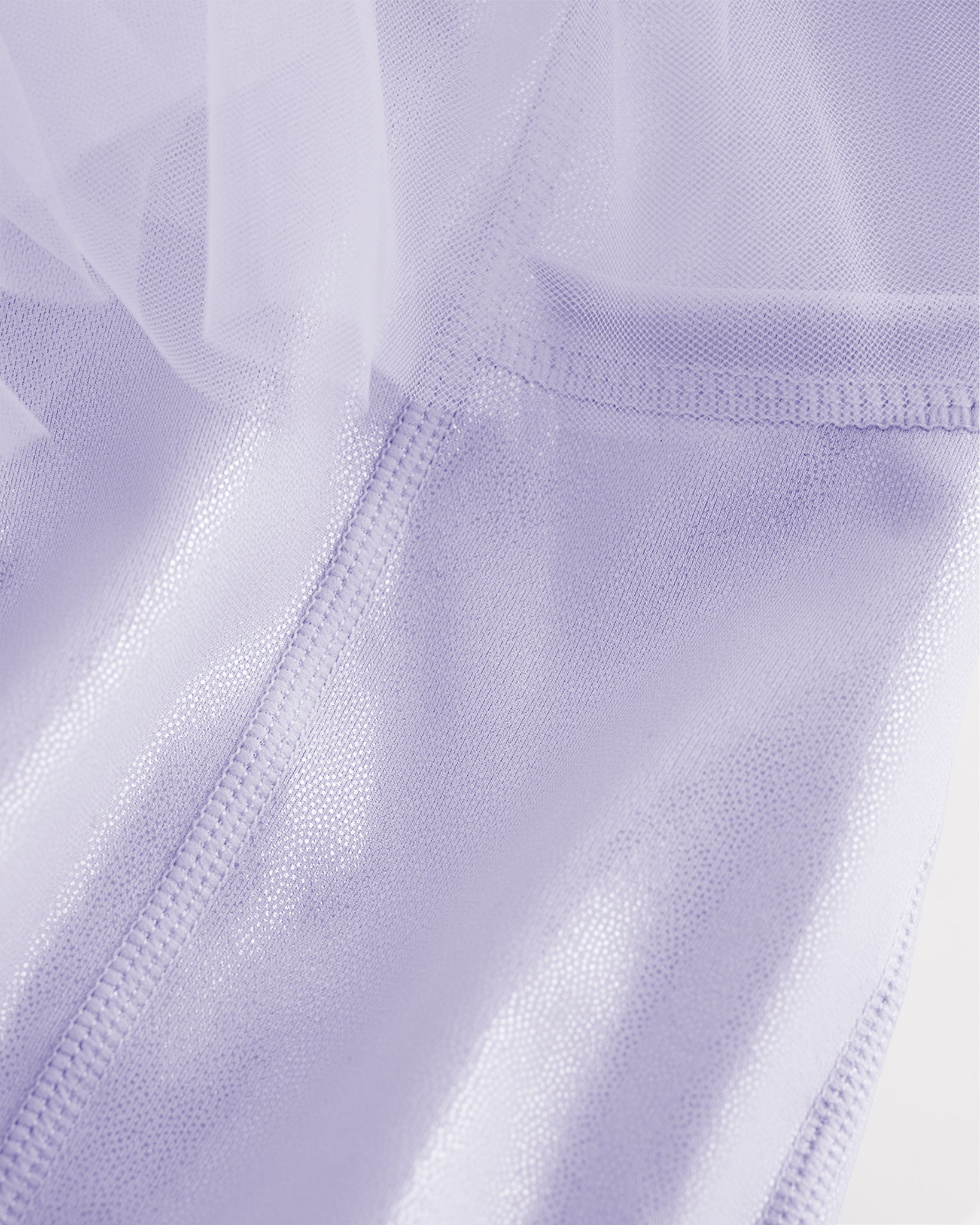 Close-up of lavender skort for girls showing sheer tiered mesh and shiny built-in shorts.