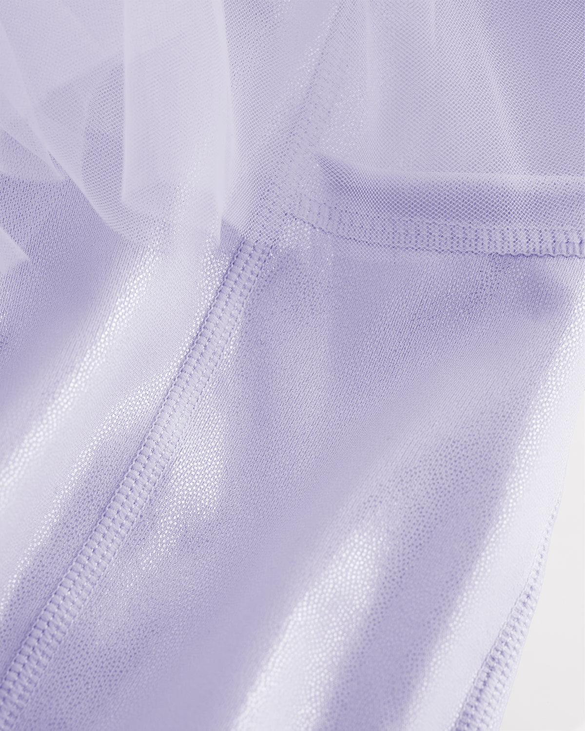 Close-up of lavender skort for girls showing sheer tiered mesh and shiny built-in shorts.
