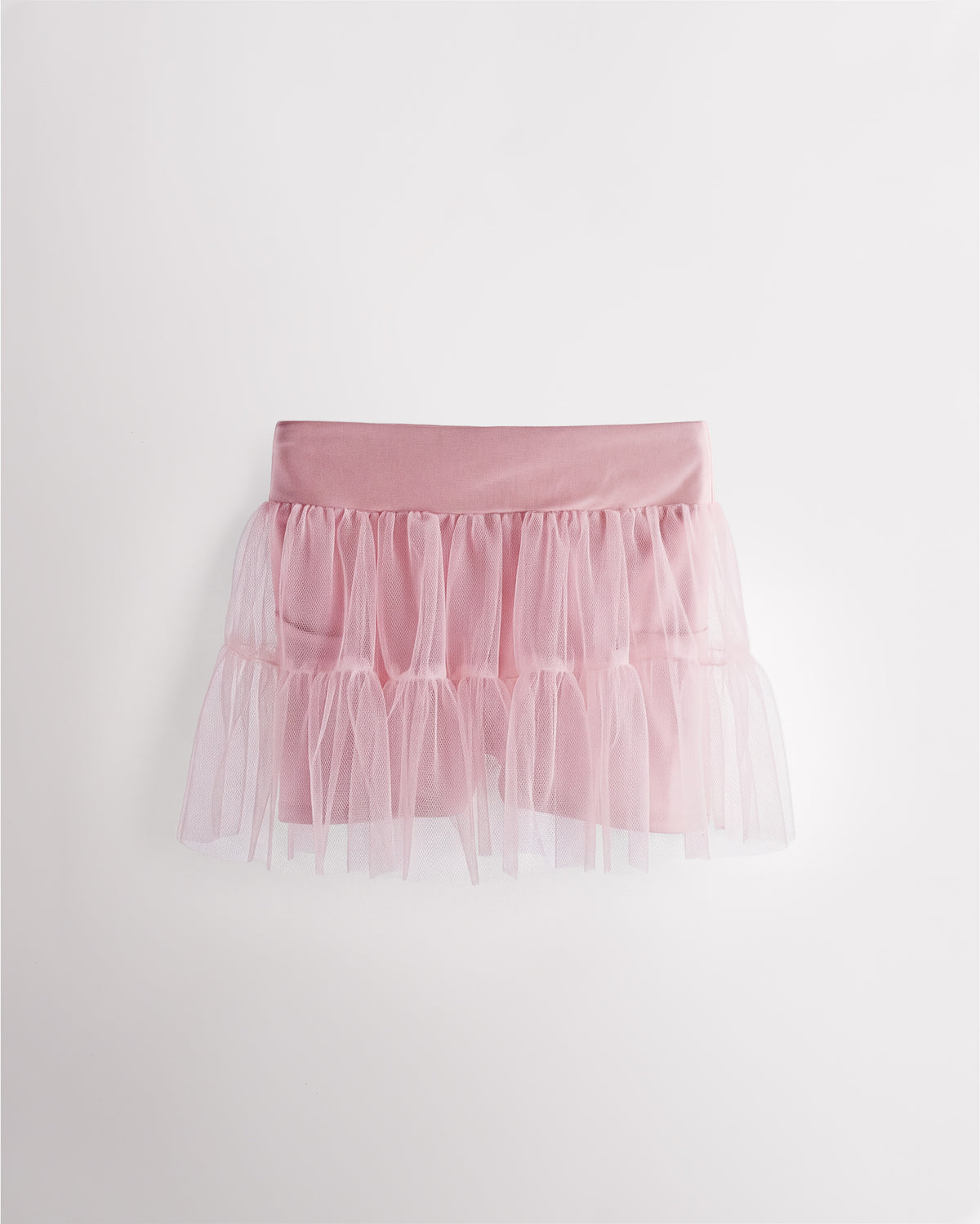 Pink girls layered skort with a high-waisted fit, tiered mesh skirt, and built-in shimmer shorts.