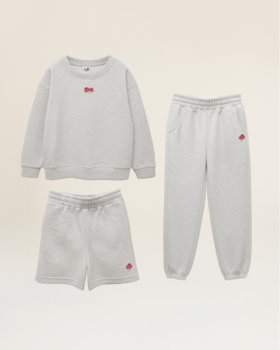 Gray sweatshirt, shorts, and jogger pants set on a beige background