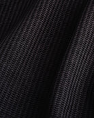 Close-up of the black waffle knit texture on the Stelle kids lounge set.