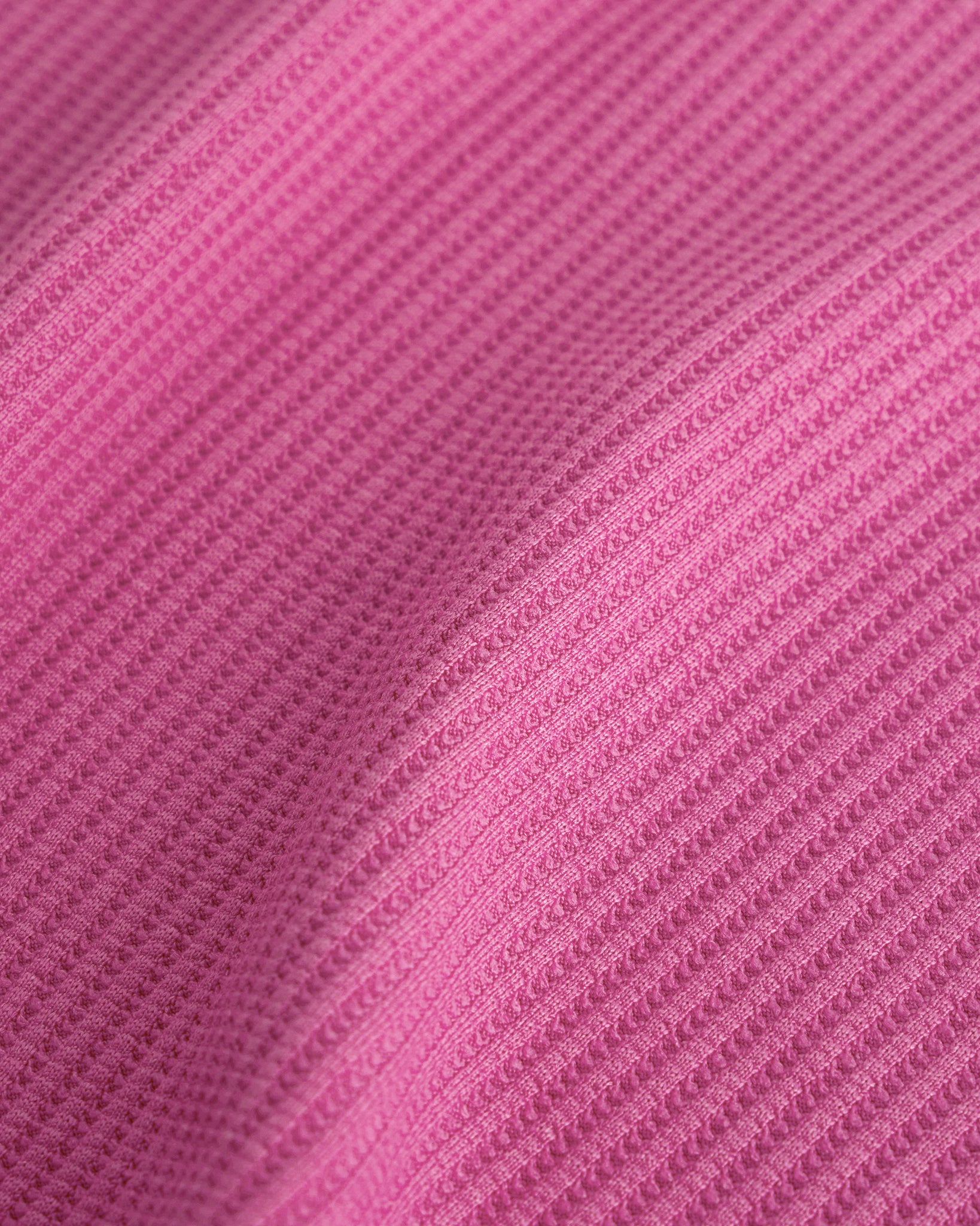 Close-up of the Dreamhouse Pink waffle knit texture on the Stelle kids lounge set.