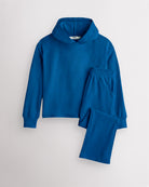 Navy Stelle kids waffle knit lounge set with a hooded top and matching pants, laid flat on a grey background.