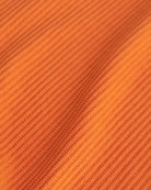 Close-up of the orange waffle knit texture on the Stelle kids lounge set.