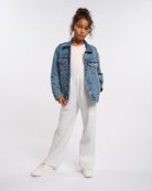 Girl styling Stelle Fleece Out Kids Sweatpants in Light Heather Grey with a denim jacket and white sneakers, casual full-length look