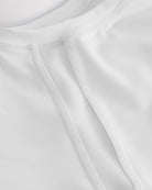 Close-up of kids athletic t-shirt mesh panel and flatlock seams showing breathable fabric and stitching detail.