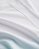 Close-up of Stelle kids ombre athletic t-shirt showing white mesh paneling, smooth seams, and aque blue gradient fabric