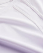 Close-up of Stelle kids ombre athletic t-shirt showing white mesh paneling, smooth seams, and lavender gradient fabric.