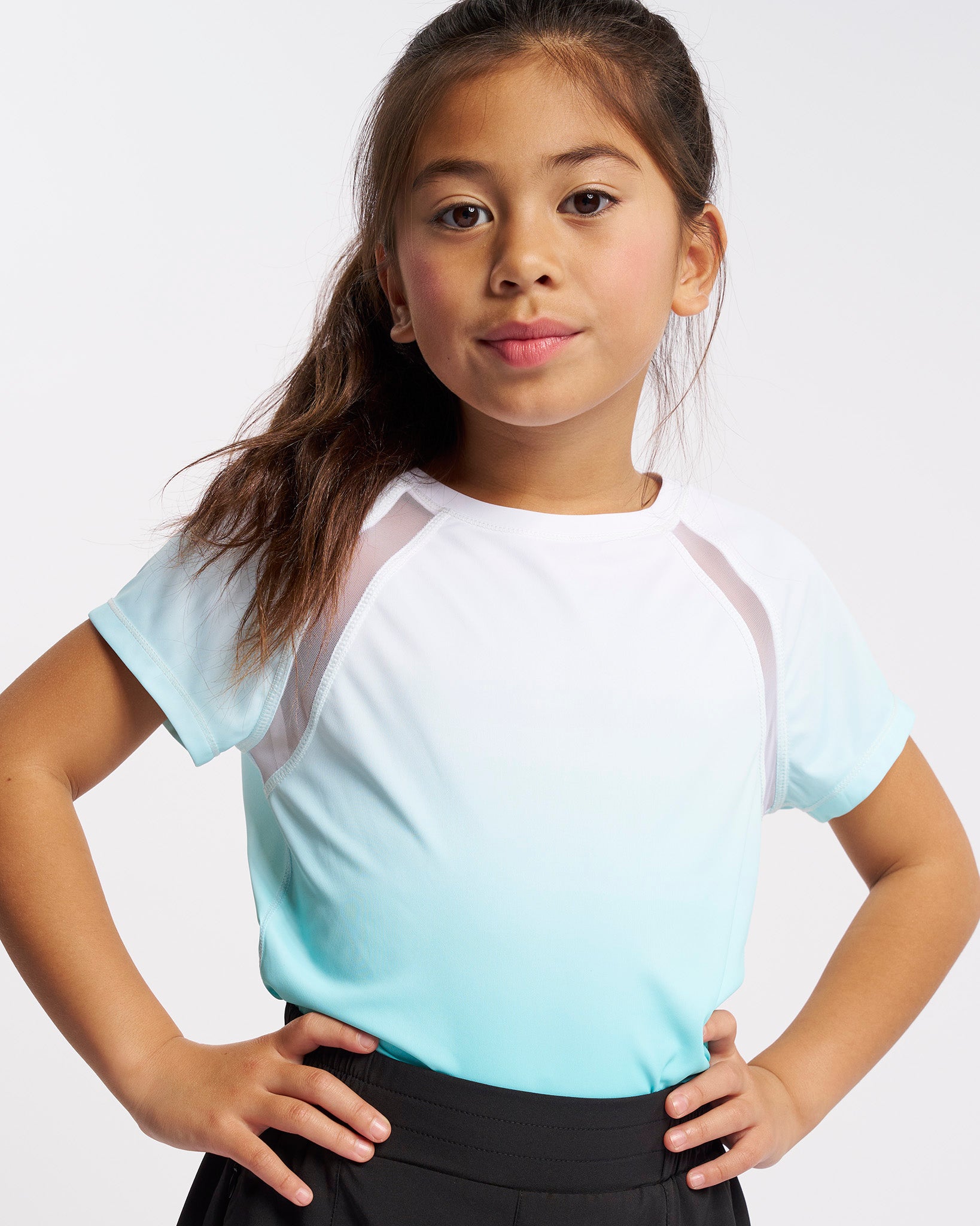 Girl wearing Stelle kids ombre athletic t-shirt with mesh paneling and aque blue gradient design