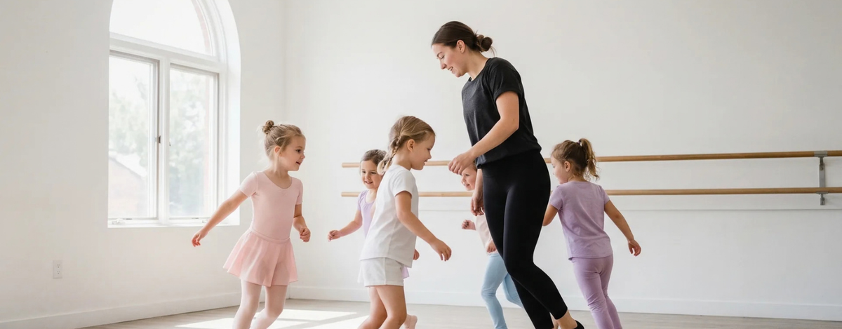 Kids following a contemporary dance teacher across the floor of a bright studio