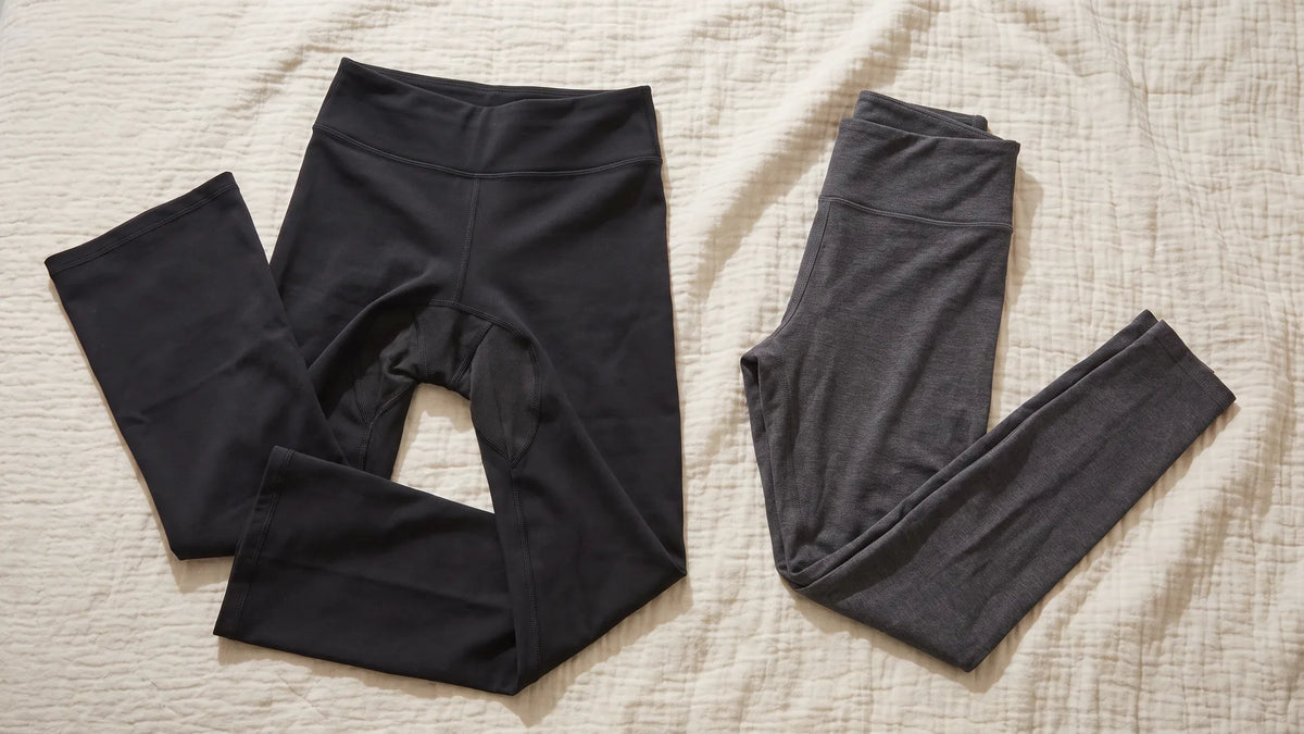 Bootcut yoga pants and slim leggings laid side by side, showing the real differences between leggings and yoga pants